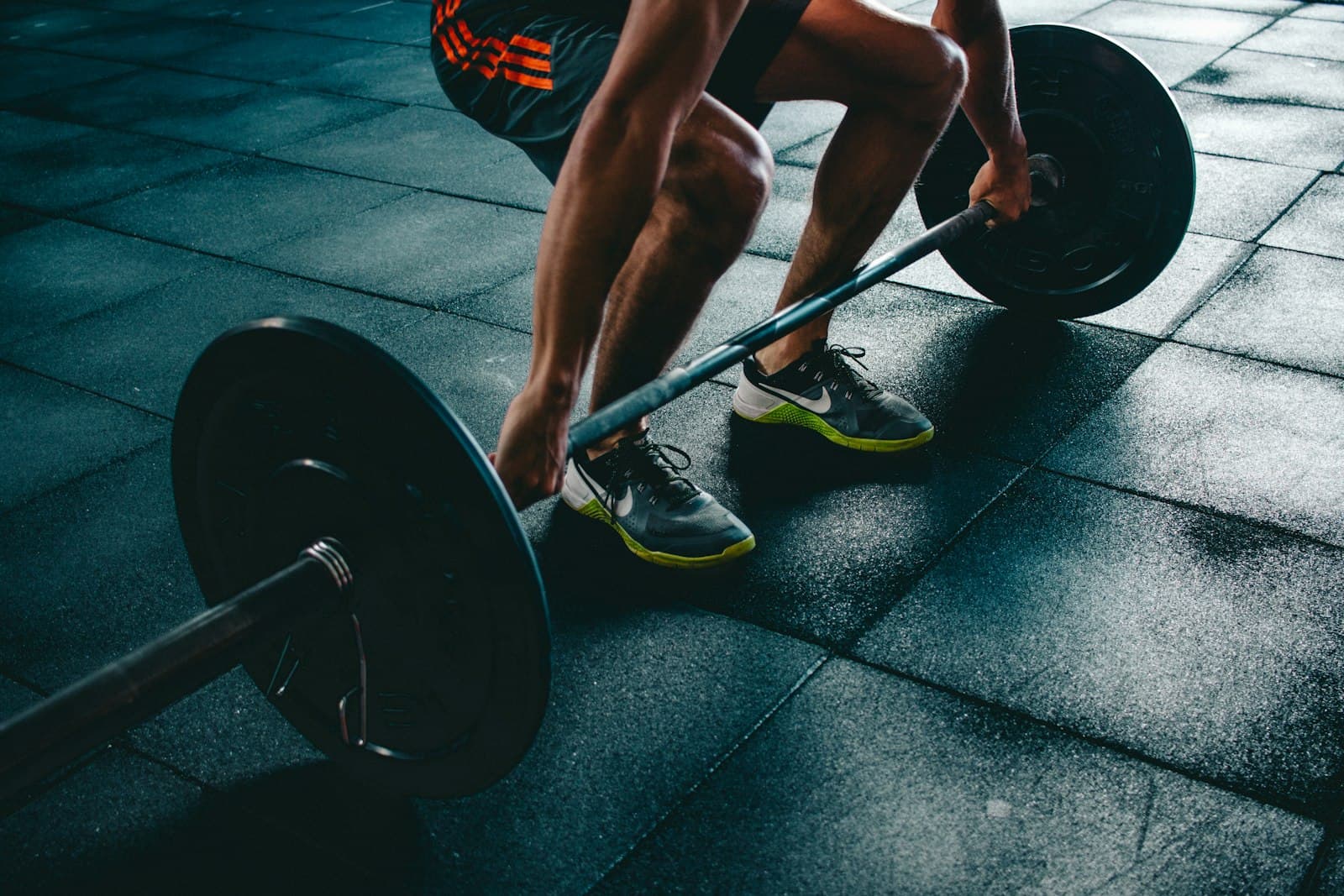 Athlete setting up a deadlift in a gym